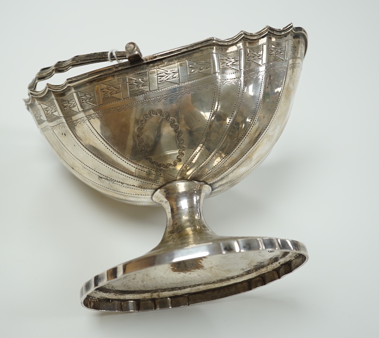 A George III Irish engraved silver bats wing oval shaped pedestal sugar basket, by Richard Sawyer, Dublin, 1803, length 17.5cm, 9oz.
